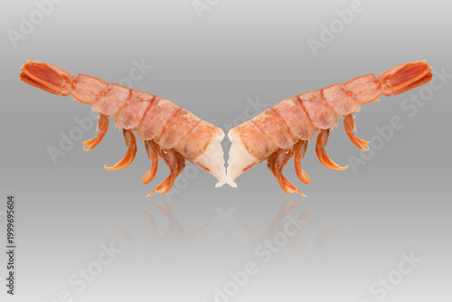 Langoustine tail on a grey background. Fresh langoustine tail close-up isolated on a grey background.