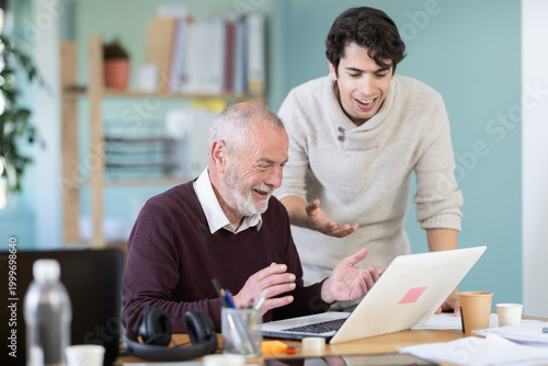 Bilde på lerret Surprised and joyful men looks at laptop monitor screen