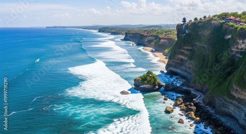 Stunning aerial view of Uluwatu cliff with crashing waves and temple architecture in Bali
