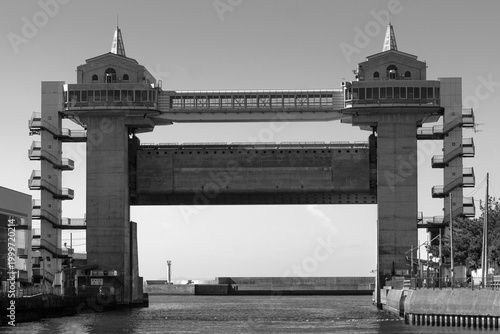 Massive concrete water gate structure with a skybridge connecting two towers,Numazu Port Observatory Water Gate 