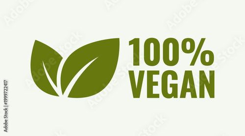 A green vegan logo with leaves and text on a light background