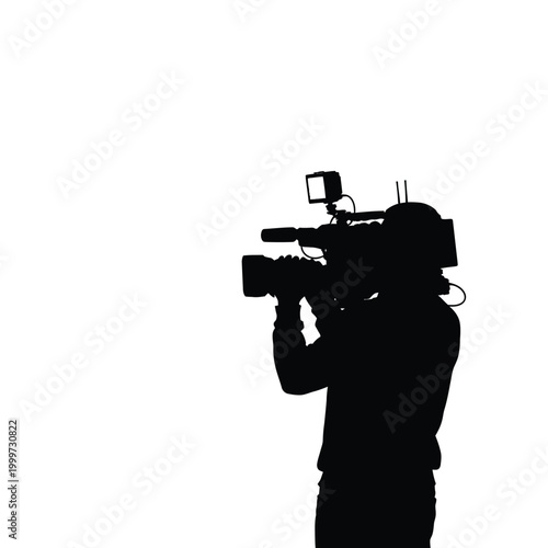 Silhouette of a person operating a professional video camera for film production