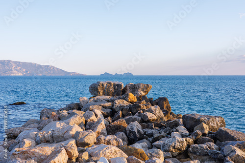 Rocky breakwater stretching into the blue sea