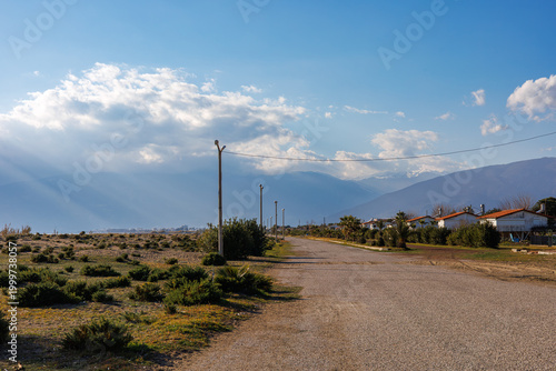 Gravel road leading to coastal town at sunset