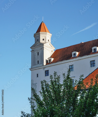 Tower of Historic Bratislava Castle with Red Roof against Clear Blue Sky, Famous Slovakian Landmark and Cultural Heritage Architecture, Scenic Travel Photography of Eastern Europe Capital City.