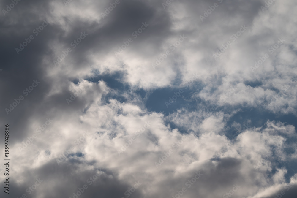 Fototapeta premium Calm clouds in clear sky. Serene bright sky filled with soft clouds and gentle glow. Tranquil midday sky featuring billowy clouds and atmosphere of peacefulness