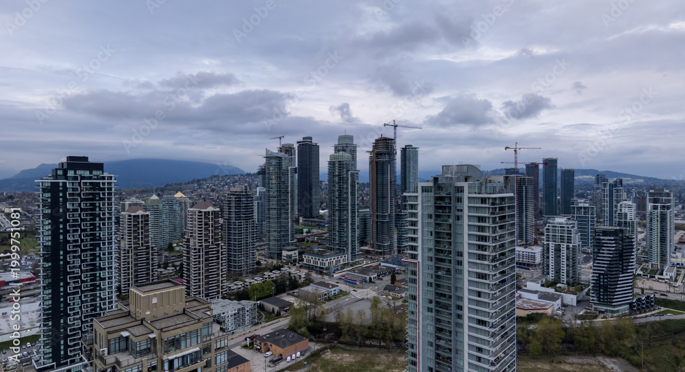 Obraz premium Burnaby City Skyline With High-Rise Towers and Construction Cranes Over Greater Vancouver, British Columbia