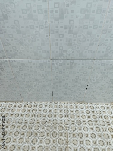 White Geometric Wall Tiles Meeting Beige Patterned Floor Tiles