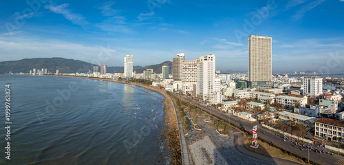 Tableau sur toile A panoramic view of the coastal city of Quy Nhon, Binh Dinh, Vietnam, showcasing its modern skyline with high-rise buildings along the beach and the East Sea