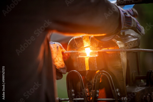 laborer manipulating metal with heat