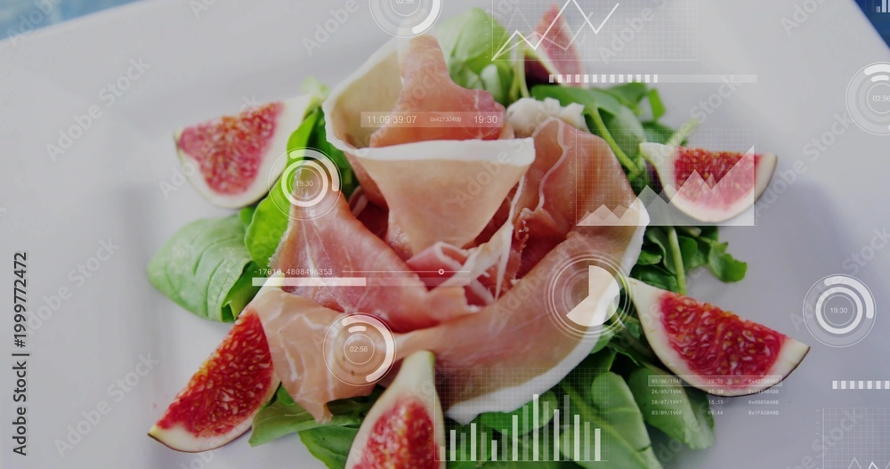 Fototapeta premium Showing prosciutto rosette resting on greens on white plate on tabletop, with figs and HUD overlays