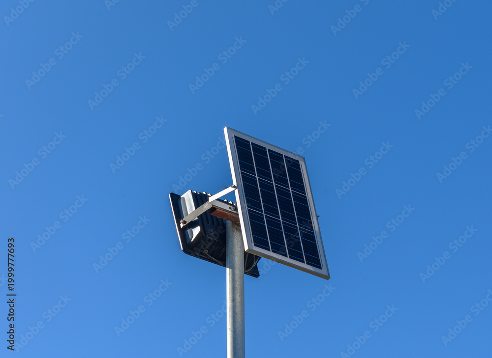 Obraz premium Bright solar panel stands tall against clear blue sky in sustainable energy revolution.