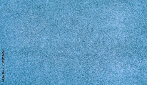Suede texture of blue color as a background macro photo.