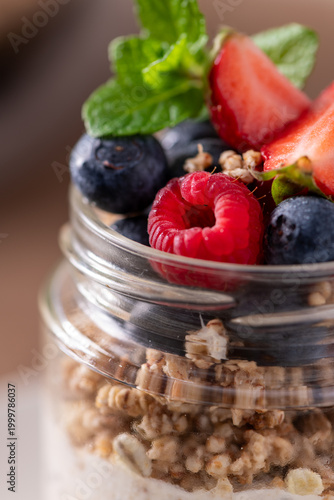 Fresh Yogurt Parfait with Granola and Mixed Berries Garnished with Mint