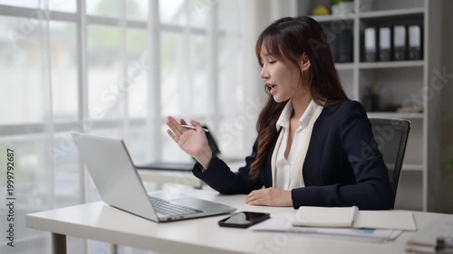 Businesswoman having video conference on laptop in office