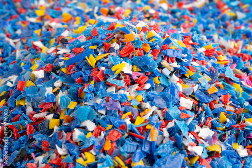 Photos Plastic colorful pieces recycling shredded for industrial use.