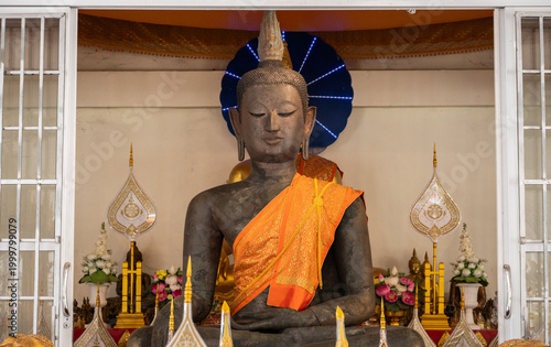 An ancient bronze Buddha statue after discovery and dig it up from island on Mekong river. This Buddha situated at Wat Thong Thip Pattanaram, Laos.