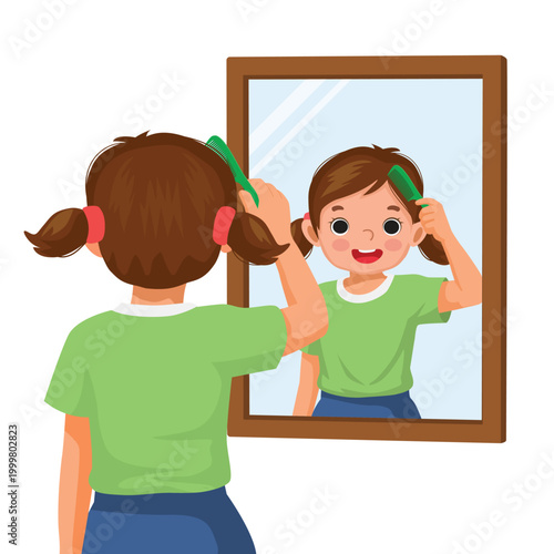 Little girl combing her hair in front of mirror