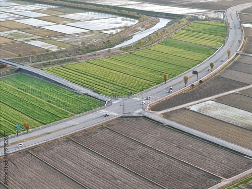 Aerial view of rural farmland intersected by a winding road