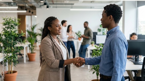 Two Colleagues Shaking Hands In Office.