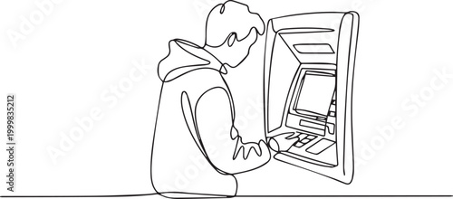 Person in hoodie using an atm machine at night