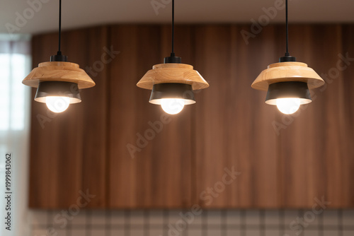 Set of Three Modern Nordic Pendant Lights with Wood and Metal Design. interior design inspiration, home decor, and modern kitchen or dining area concepts.