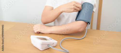 Фотография woman checking Blood pressure by Blood pressure monitor with Cuff
