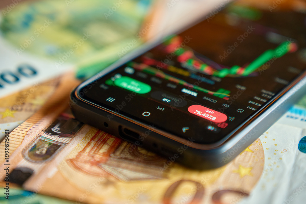 Naklejka premium Smartphone showing trading app with market chart on euro banknotes. Concept of online investment, financial risk, mobile trading and digital finance.