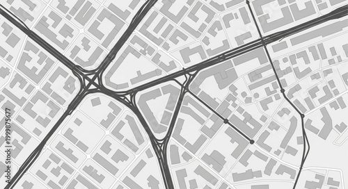 Aerial view of a complex highway interchange and city grid.