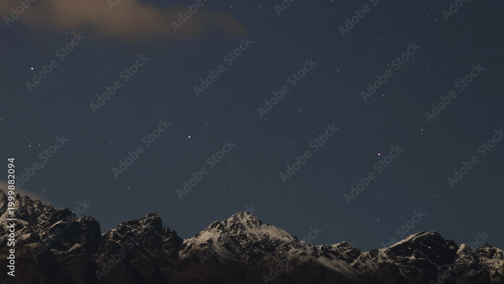 Fototapeta premium Starry Night Sky Over Snow Capped Mountain Peaks in Queenstown