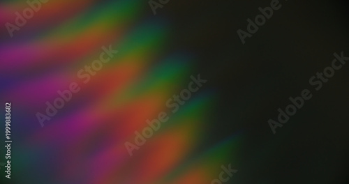 Defocused light. Colorful striped glow. Aged film art luminosity texture. Optical spectrum lines on dark black background free space.