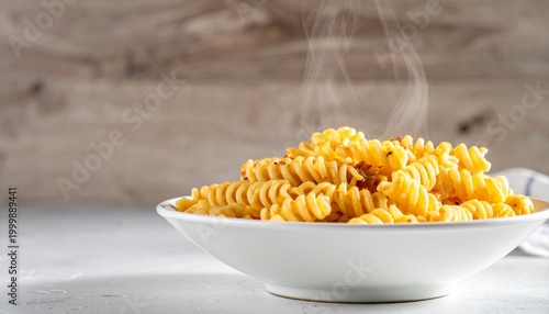 Steaming rotini pasta in a white bowl, symbolizing warmth, freshness, and appetizing comfort food.