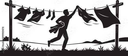 Silhouette of a Man Taking Down Laundry from a Clothesline