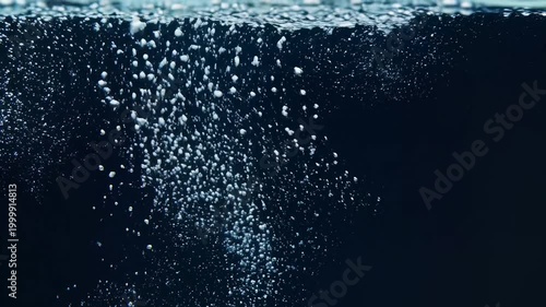 Closeup of Bubbles Rising in Dark Water.
