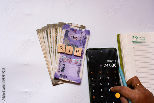 Indian Rupee Notes with Calculator and SIP Blocks Budget Planning Concept