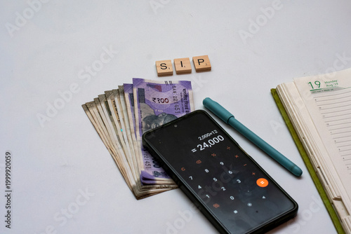 Indian Rupee Notes with Calculator and SIP Blocks Budget Planning Concept