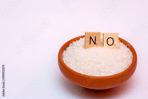 White sugar in clay pot with NO sign using wooden letters, health risk concept
