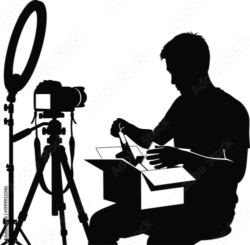 A professional cameraman stands in silhouette with his camera and tripod equipment in a digital studio
