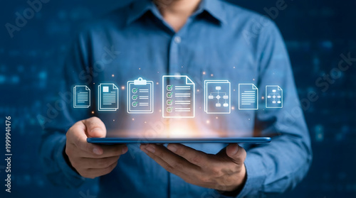 A professional holds a digital tablet displaying illuminated document management icons symbolizing modern business data organization