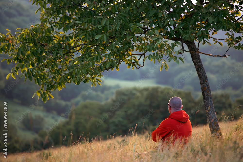 Naklejka premium Man sitting in nature