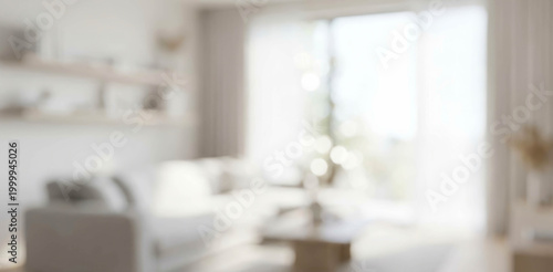 A softly blurred image of a bright and modern living room, featuring comfortable seating, natural light, and stylish decor elements creating a warm atmosphere.