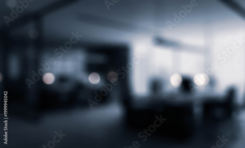 A blurry image depicting a modern office interior with soft lighting, conveying a sense of tranquility and minimalism. Ideal for corporate or workspace themes.