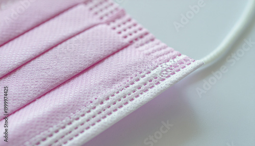 Close up texture of a pink medical disposable face mask