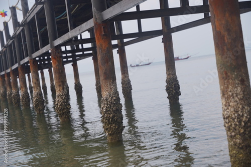 Wooden pier perspective over calm sea with reflections
