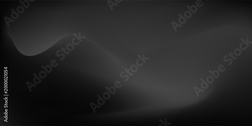Empty dimly lit studio or stage featuring a black leather texture on floor. Single spotlight from above illuminates the ground creating  subtle gradient effect against the otherwise dark background