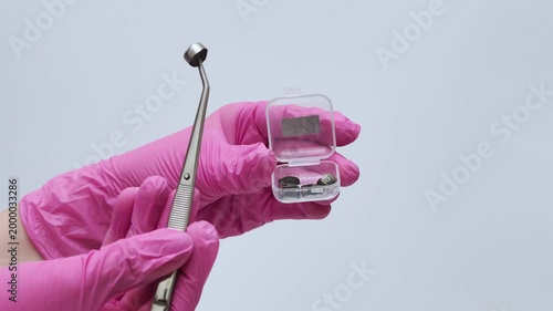 Close-up of Scientist Hands in Pink Gloves Handling Material Samples with Tweezers
