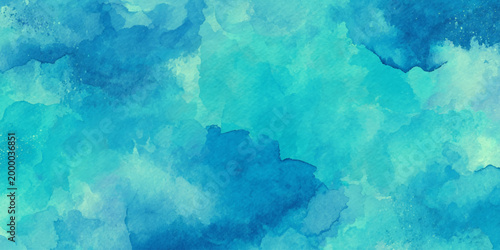 Vibrant blue watercolor background with abstract cloudy texture and splatters for creative design projects and artistic applications