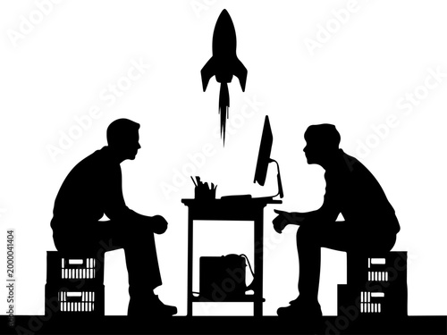 Silhouette of Two Men Working at a Desk with a Rocket Launching Upward Representing a New Business Startup and Success