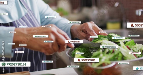 Slicing senior-Indian making salad in kitchen wearing apron holding knife over colander with tags