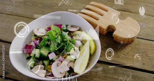 Displaying white ceramic bowl holding salad on rustic table, showing wooden servers and AR overlays